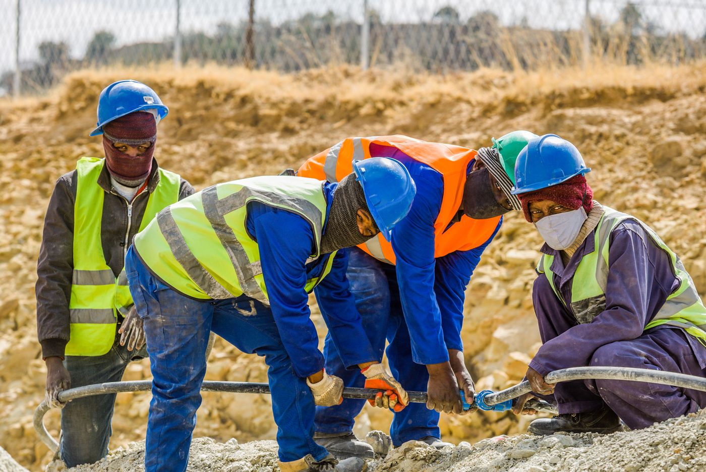 Construction workers coordinating on an active job site
