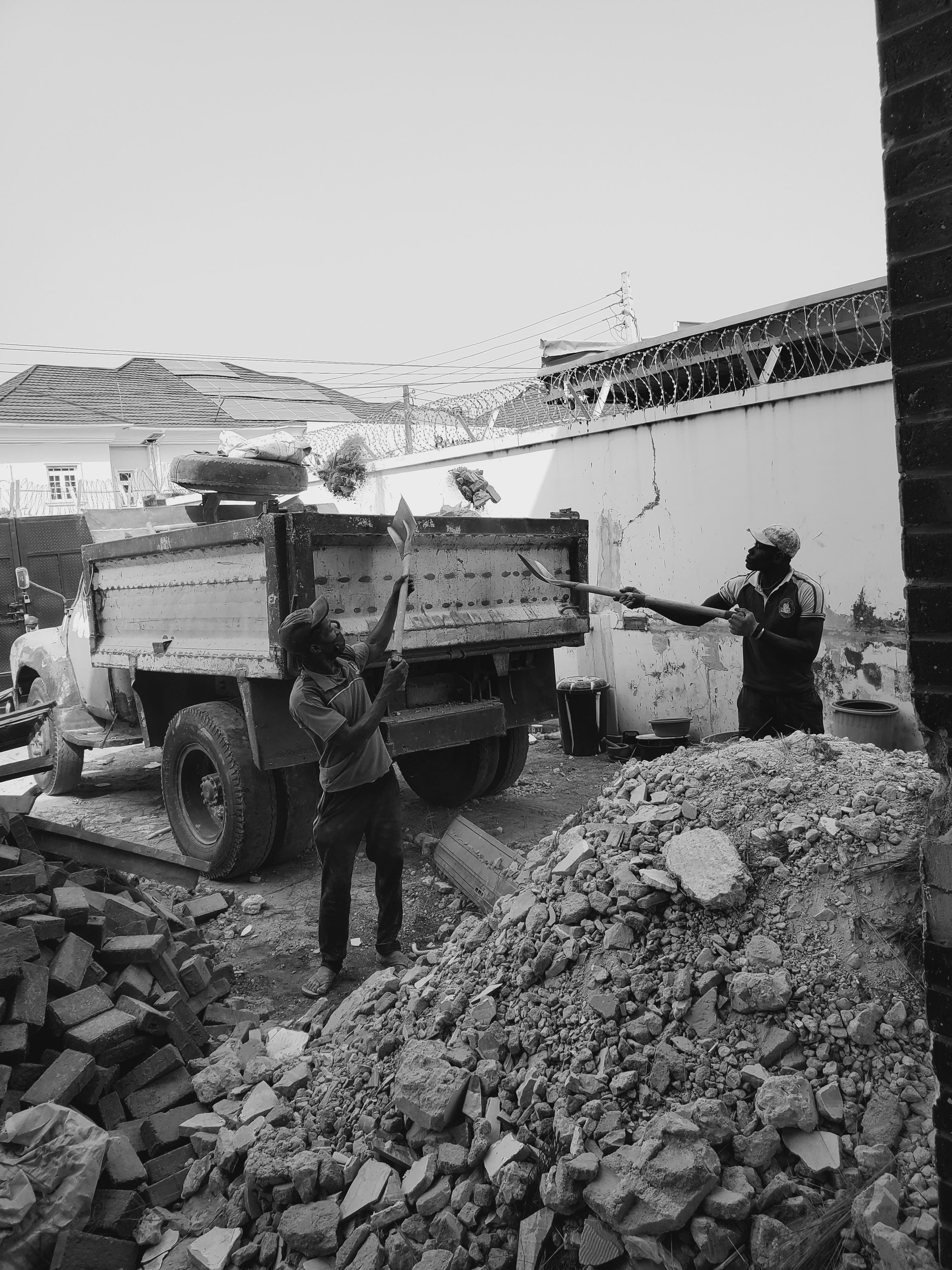 Nigerian construction workers loading debris at a worksite in Lekki